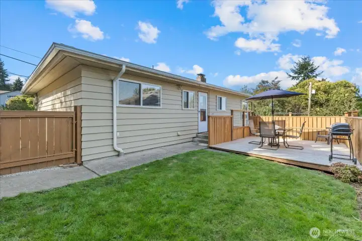 Enclosed yard space with new deck off kitchen