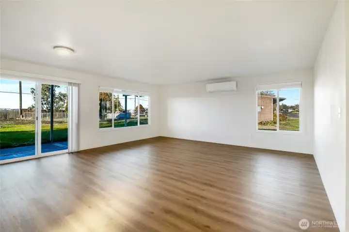 New flooring and new windows! Living room with sliding doors to the back patio.