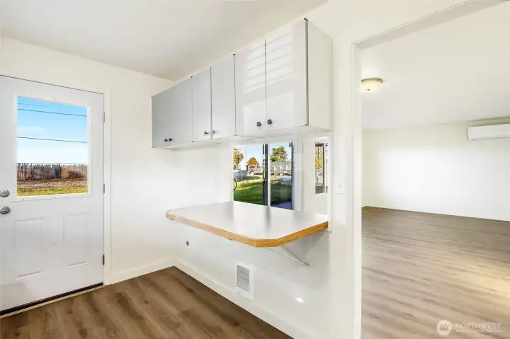 The back door in the kitchen leads out to the covered back patio.  You'll enjoy new flooring in the kitchen and living room.