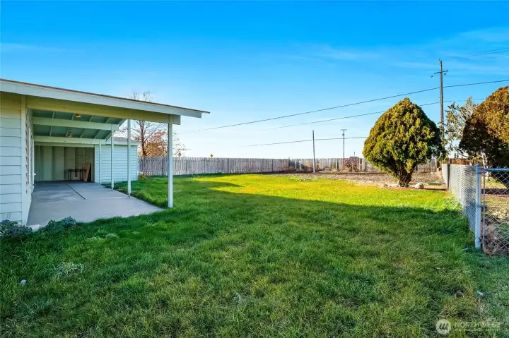 The backyard is almost fully fenced, and you have a lot of grass, but not too much!  You'll love the covered back patio!