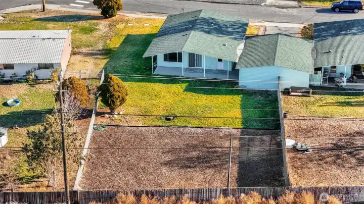 Drone view from the back of the property shows all of the bark and backyard lawn.