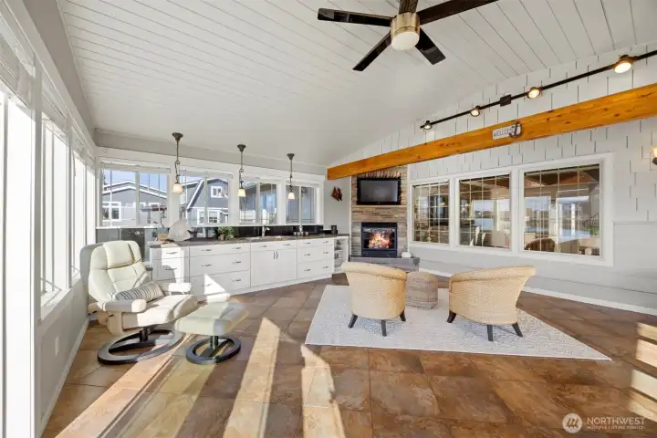 This room has so much space that it can accommodate areas for relaxing AND dining AND even a puzzle table as well!