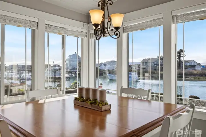 Dining area in the sunroom; there is sliding door to an additional paved patio on the side that is perfect grilling space