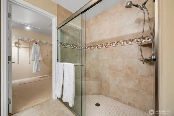 A zero entry shower and a massive walk in closet