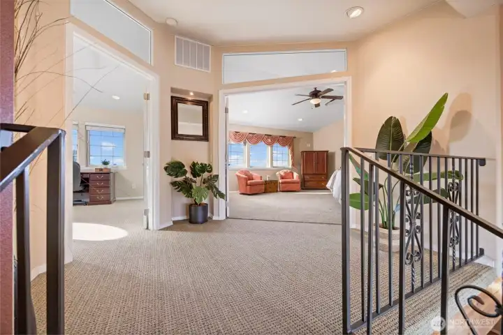 A spacious landing with the second primary bedroom suite to the right and the 4th bedroom (currently used as an office) to the left