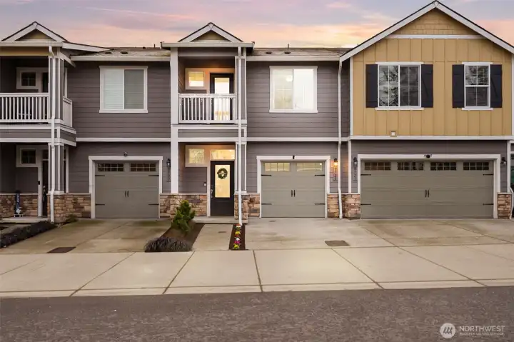 Move-in ready and well maintained townhome exterior with attached garage and newly pressured wash driveway.