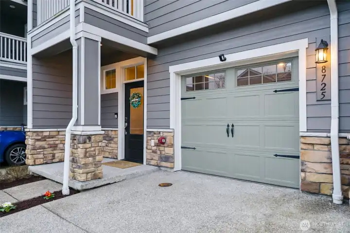 Attached garage with private front entry and covered porch.