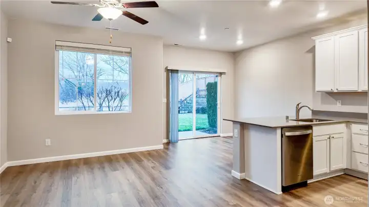 Open concept living and dining area with abundant natural light and direct access to the patio.