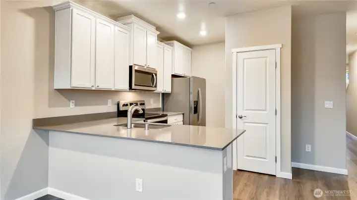 Well appointed kitchen featuring ample cabinetry, stainless appliances, and generous counter space.