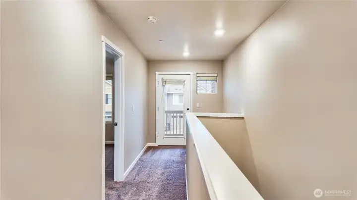 Upstairs hallway with natural light and access to secondary bedrooms.