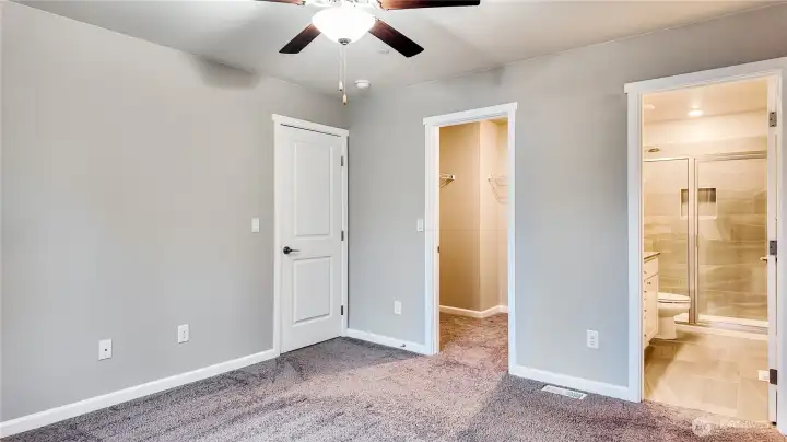 Spacious primary bedroom with ensuite bath and walk in closet.