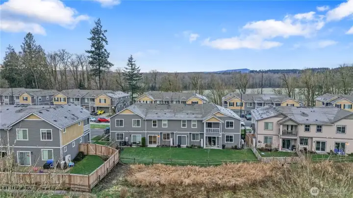 Aerial view backing to open green space.