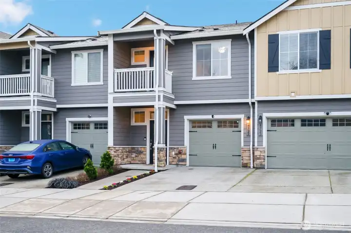 Clean curb appeal with private garage and welcoming entry.