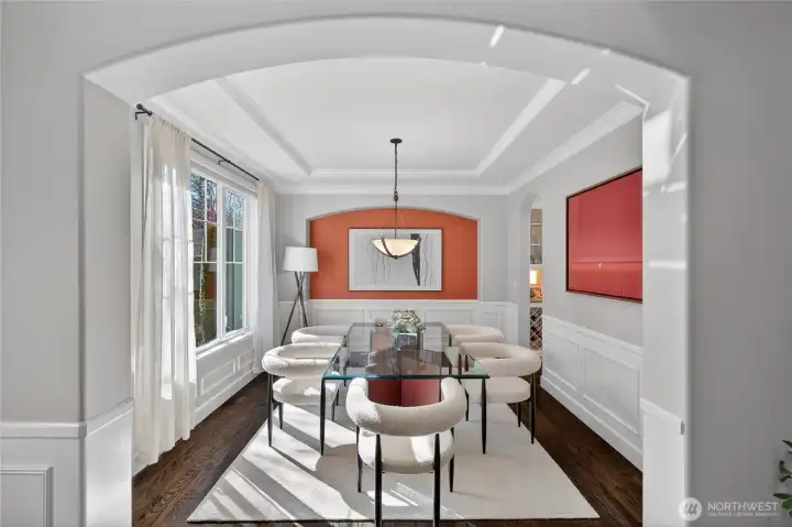 Formal dining room with wainscoting, trey ceiling, and curved entry for a truly magnificent room.