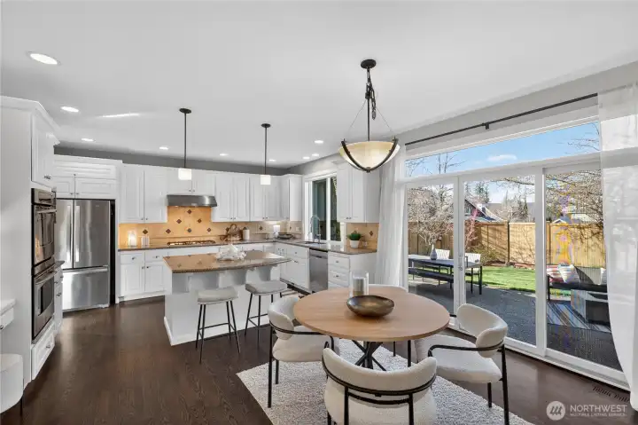 Kitchen is open to a breakfast area and filled with natural light from the large windows & slider to the patio.