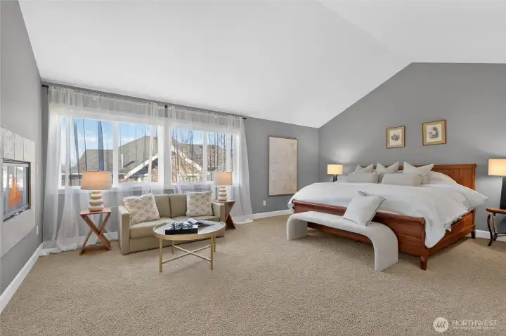 Oversized primary suite with cathedral ceilings.