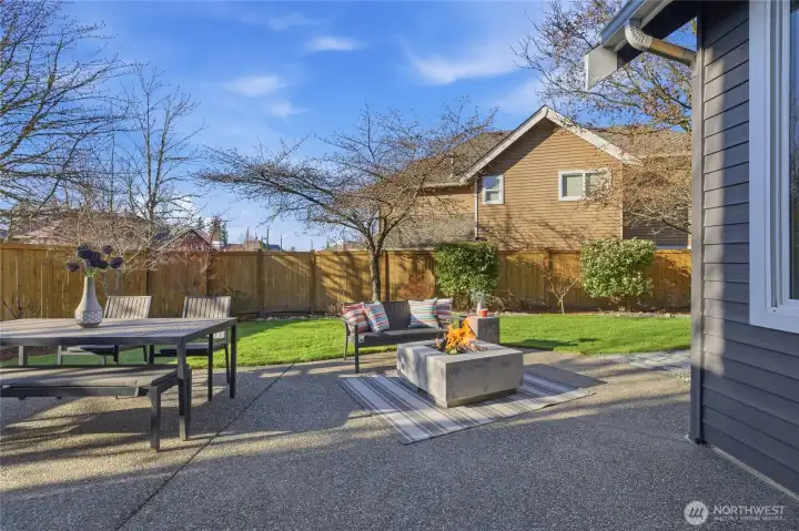 Paved patio, stone walkway, and firepit extend the living space to outdoors.