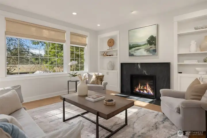 Regency gas fireplace with soapstone surround, framed by built-in cabinets and an art niche with lighting.