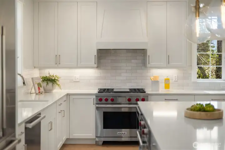 Carrara Grey Quartz Counters. Wolf range plus additional oven in island.