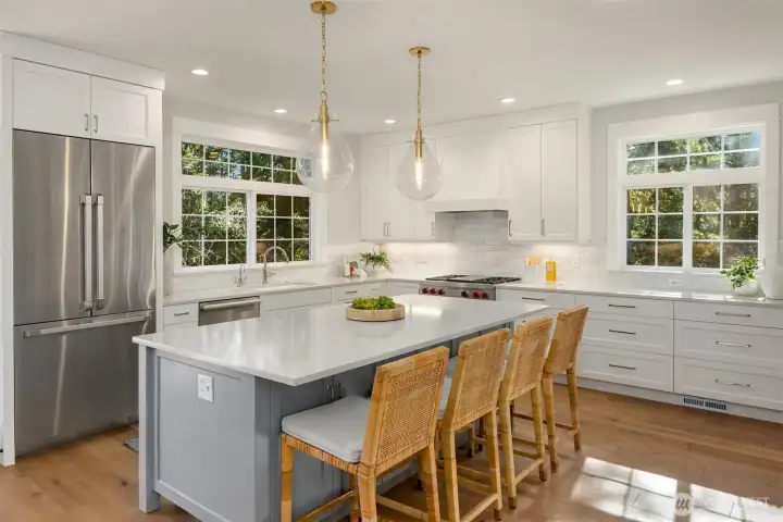 Custom Shaker cabinetry and garden view windows.
