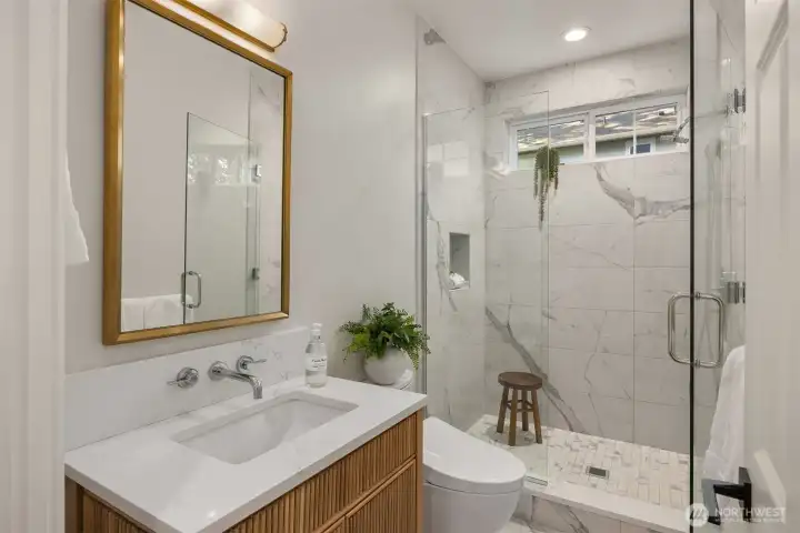 Main floor 3/4 bath. Visual Comfort Sconces. Signature Hardware fixtures