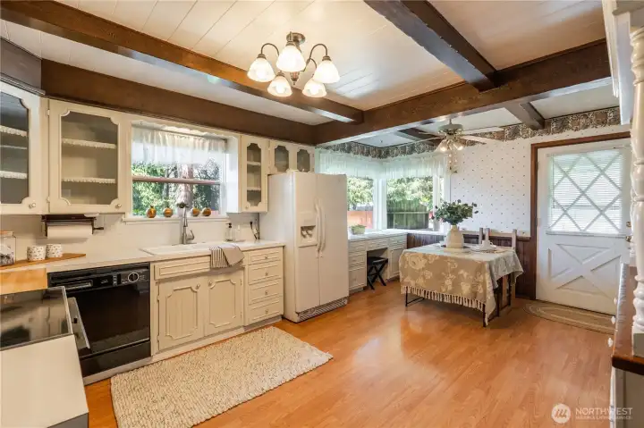 Kitchen with room to move around and ample storage. Remove the desk and create large eating space for everyone.