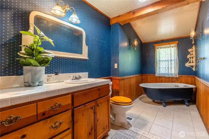 Downstairs bathroom with clawfoot soaking tub.