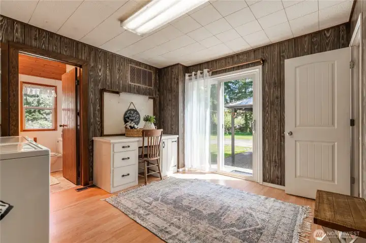 Giant mudroom and laundry. Door to right leads to upstairs. Entry at left leads to bath with walk-in shower.