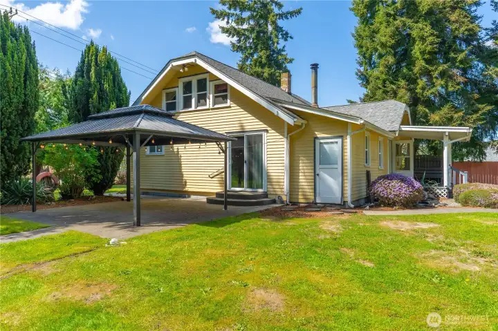 View from the side with large gazebo off of mudroom and slider access.