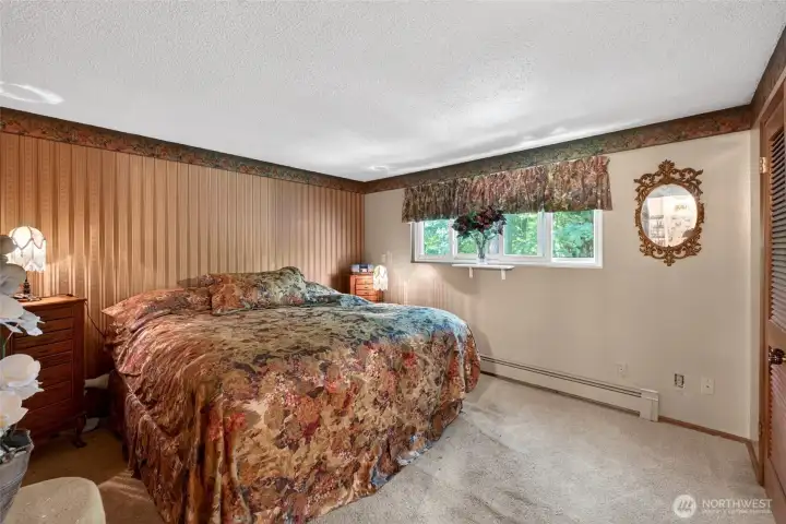 Expansive Primary bedroom on main level overlooks the beautiful greenery in the back yard. Expansive Primary bedroom on main level overlooks the beautiful greenery in the back yard.