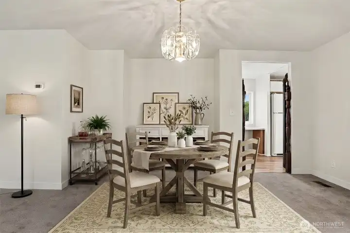 Formal dining room opens to the formal living room.  Virtually staged photo.