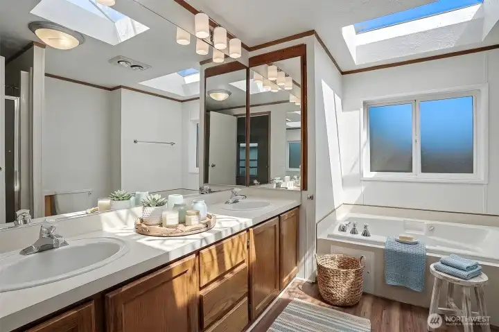 Updated 5 piece bathroom.  New LVP flooring in Bath. Virtually staged photo.