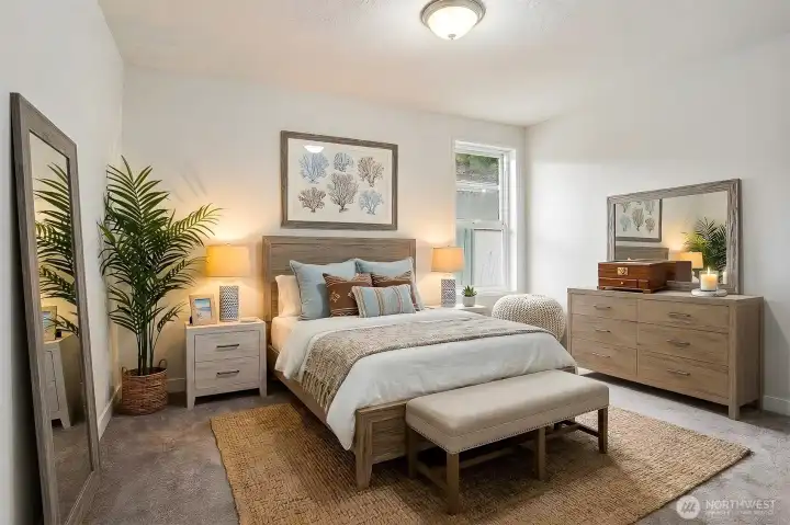 2nd bedroom with new paint and wall to wall carpet.   Virtually staged photo.