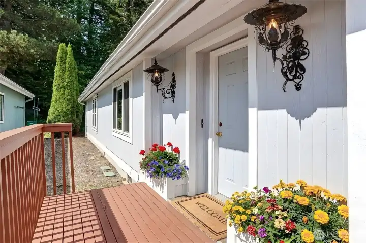 Formal entry way around off the wrap around front deck.  Virtually staged photo.