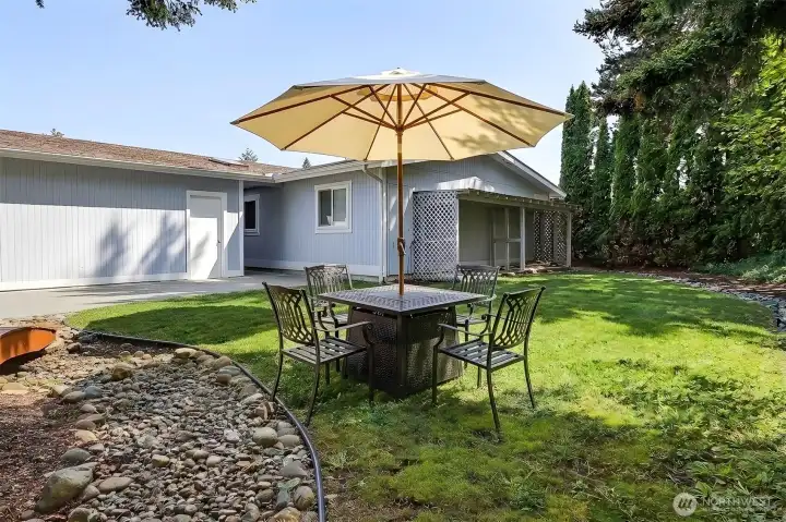 Private back yard with a patio and garden space.  Virtually staged photo.