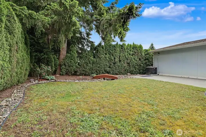 Private back yard with a patio and garden space.