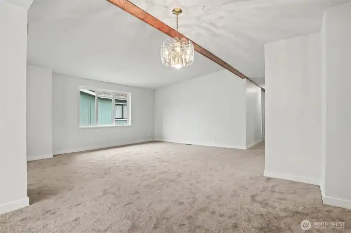 ormal living room with vaulted ceilings opens to the formal dining room.   Front entry way is on the left side.  New wall to wall carpet and interior paint.