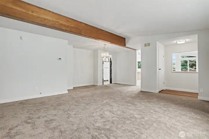 ormal living room with vaulted ceilings opens to the formal dining room.   Front entry way is on the right side.  New wall to wall carpet and interior paint.
