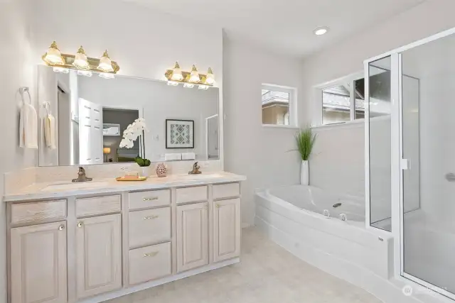 Now this is a great bathroom. Double sinks, a large soaking tub, separate shower with a bench, and a private water closet make this a dream primary bath. The high windows are great! No need for blinds or shades for privacy and you will always have an abundance of natural light flowing through.
