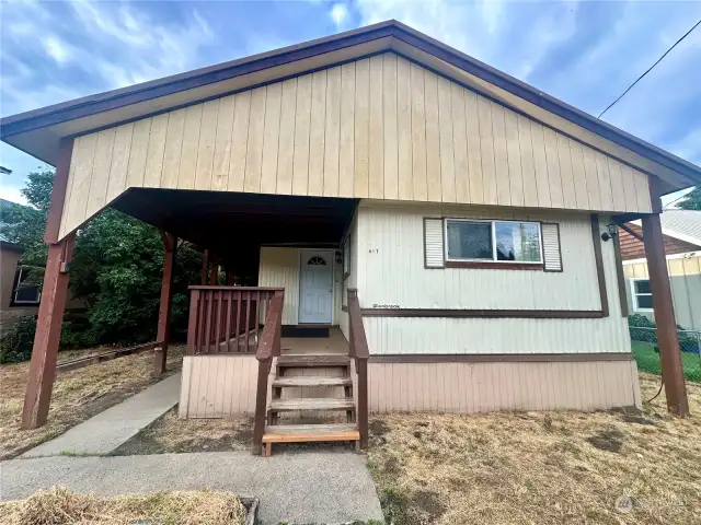 Great starter home on a fenced lot with snow shed roof and detached garage with alley access