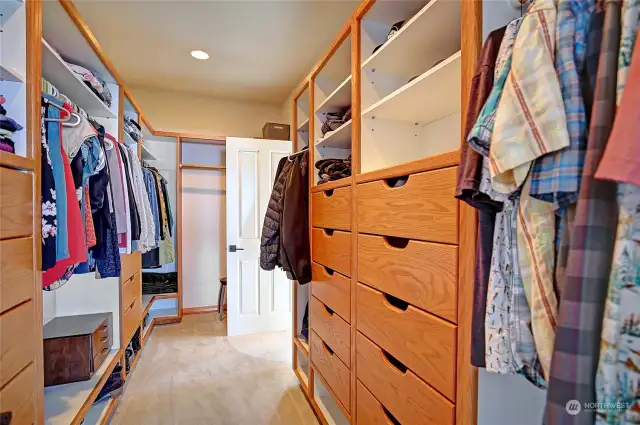 Generous walk-in closet with access off primary bedroom and bathroom.