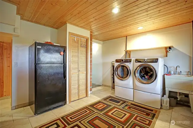 Huge laundry room/mud room with understair storeage, utility sink & access to back patio.