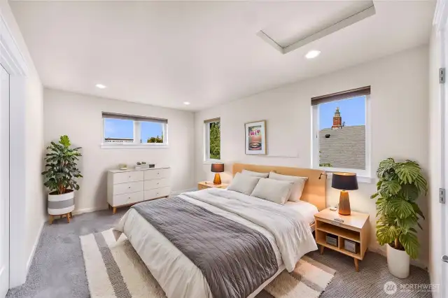 At the top of the stairs is the primary suite, virtually staged.