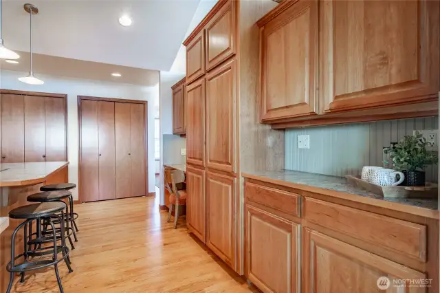Kitchen with built-in desk and loads of storage and countertops