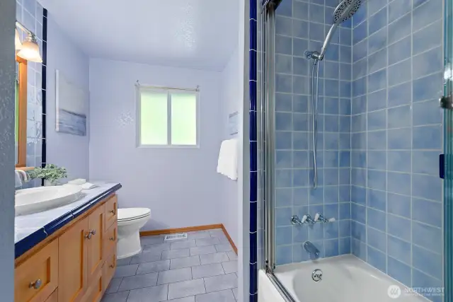 Main floor full bath with storage to the left (hidden from view)