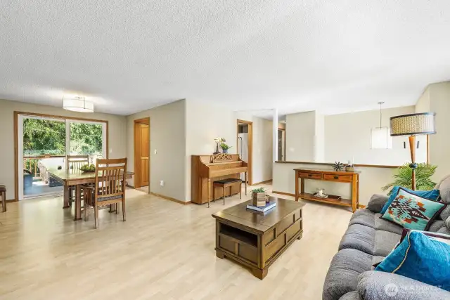 Formal dining and living combined with access to deck and kitchen.