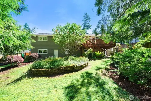 View towards the rear of the home.  To the right of the home you'll discover a greenhouse, which stays with the home.
