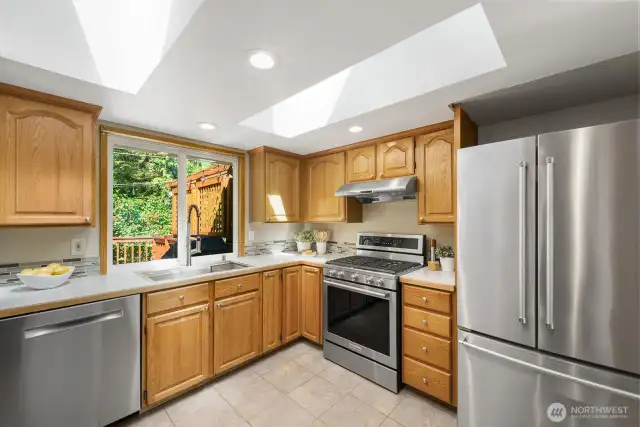 Efficient kitchen with new sink, faucet, newer stainless appliances plus gas range. Two skylights bring the light!