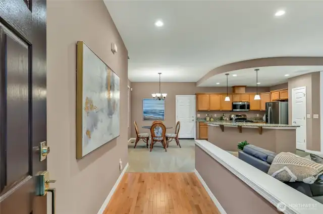 Enter the great room on warm hardwood floors.