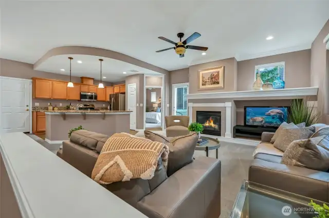 The great room is quite large and has a gas fireplace, a large TV niche and a huge display mantle.